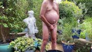 Pissing by tube nude in garden